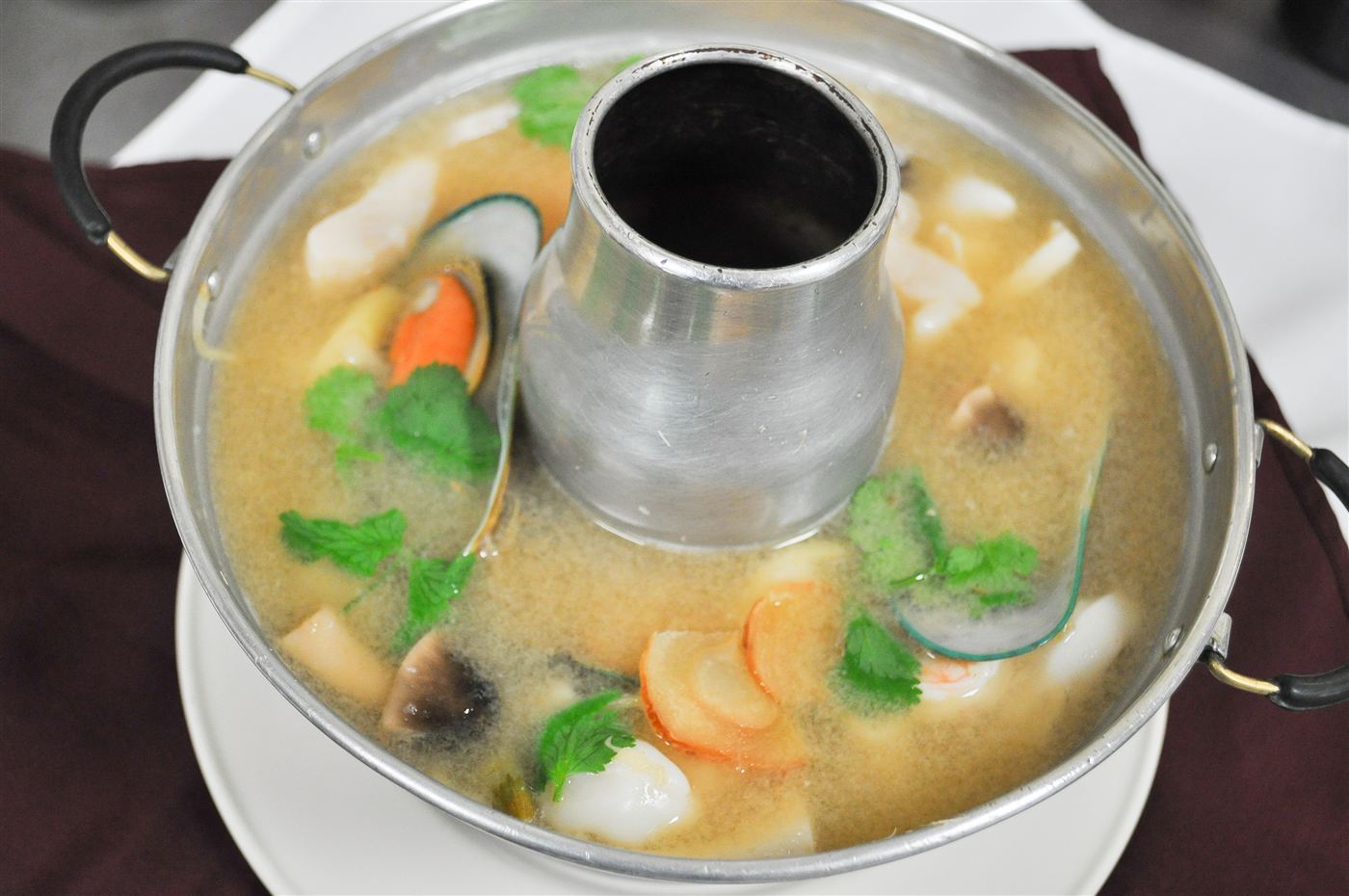 Tom Yum Seafood — Thai hot and sour soup served in a traditional fire pot